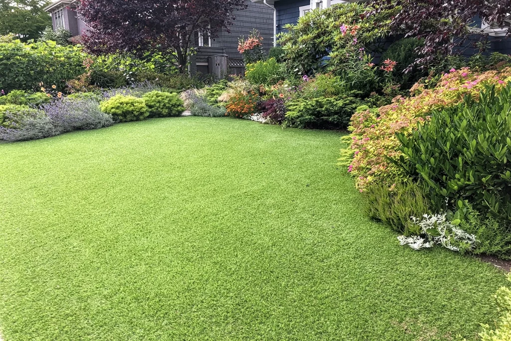 beautiful-green-front-yard-with-lots-of-newly-planted bushes-and-flowers