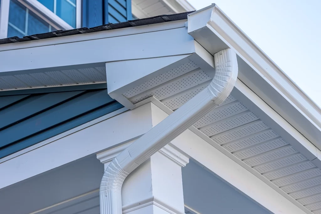 close-up-of-a-new-white-gutter-on-blue-and-white-house