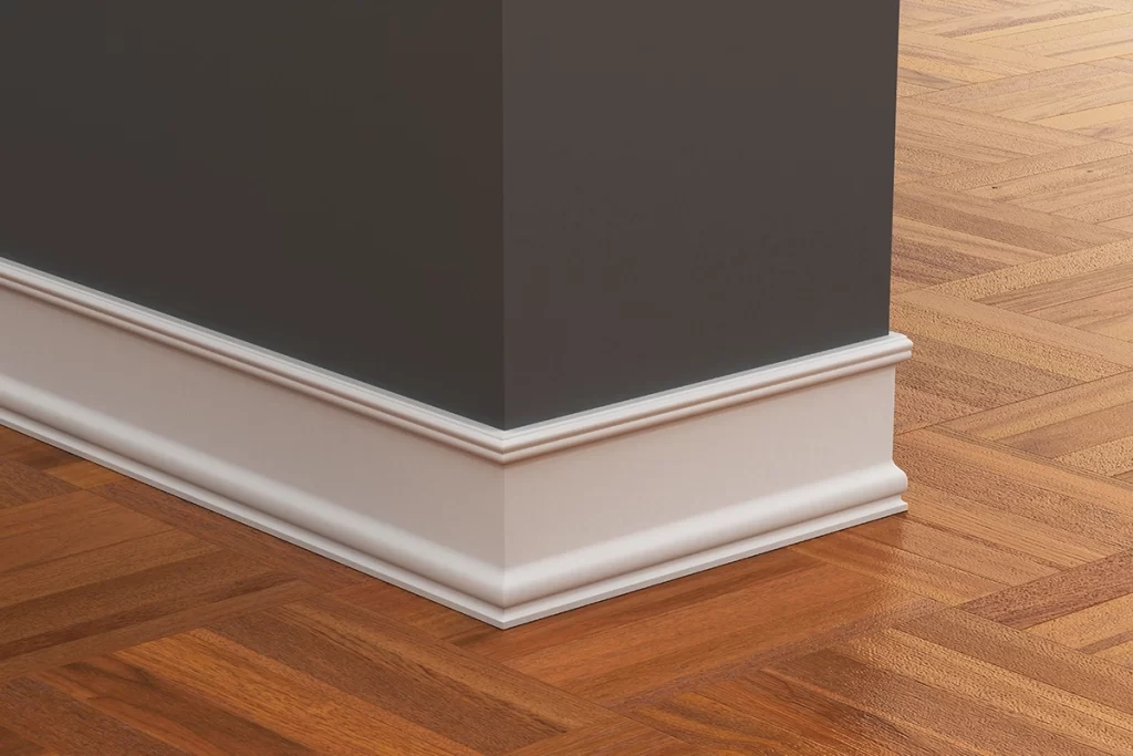 close-up-of-white-baseboard-on-brown-wall