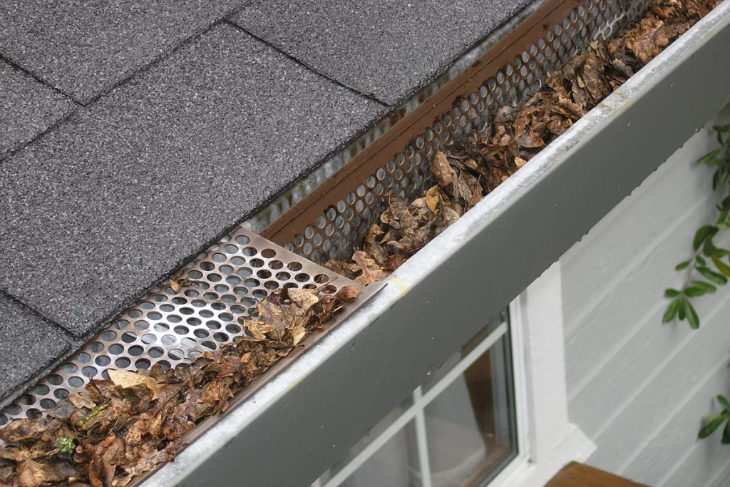 gutter-on-homes-roof-filled-with-leaves