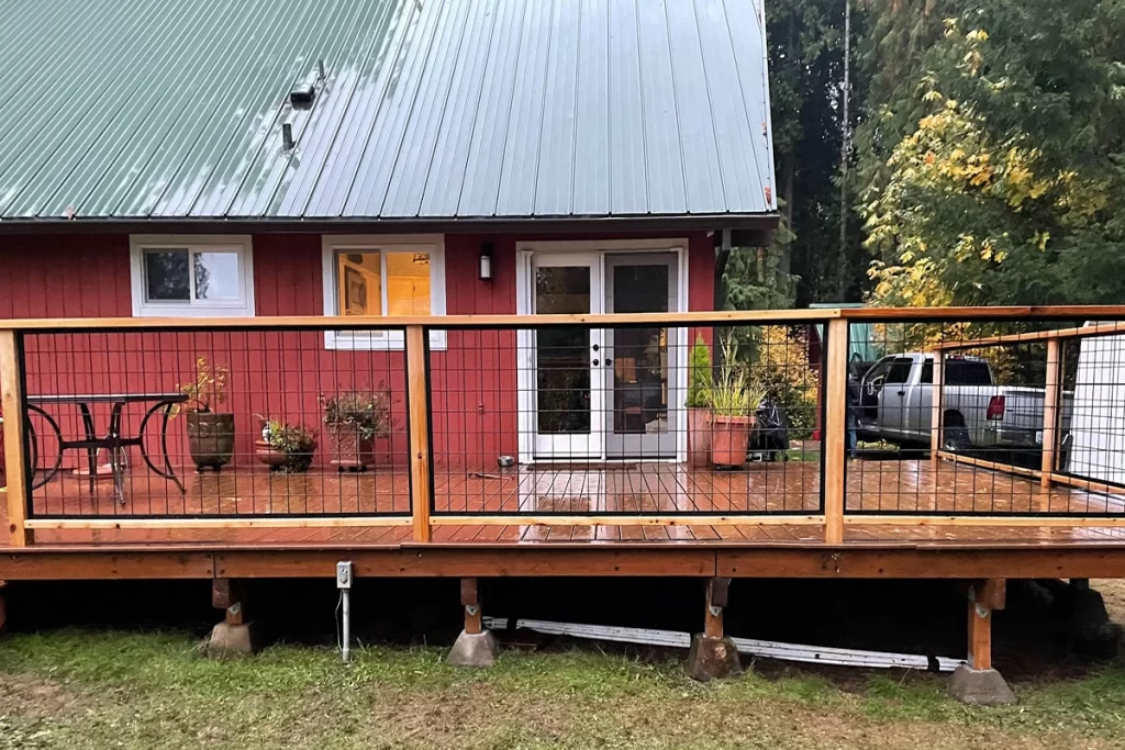 new-black-and-brown-deck-wrapping-around-a-red-house