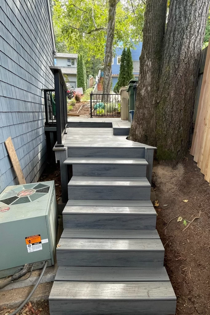 newly-installed-gray-deck-stairs-on-side-of-house